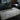 Lavico Swirl Marbled Rug Modern Abstract Silk Shiny Rug by Clarke & Clarke in Charcoal Grey